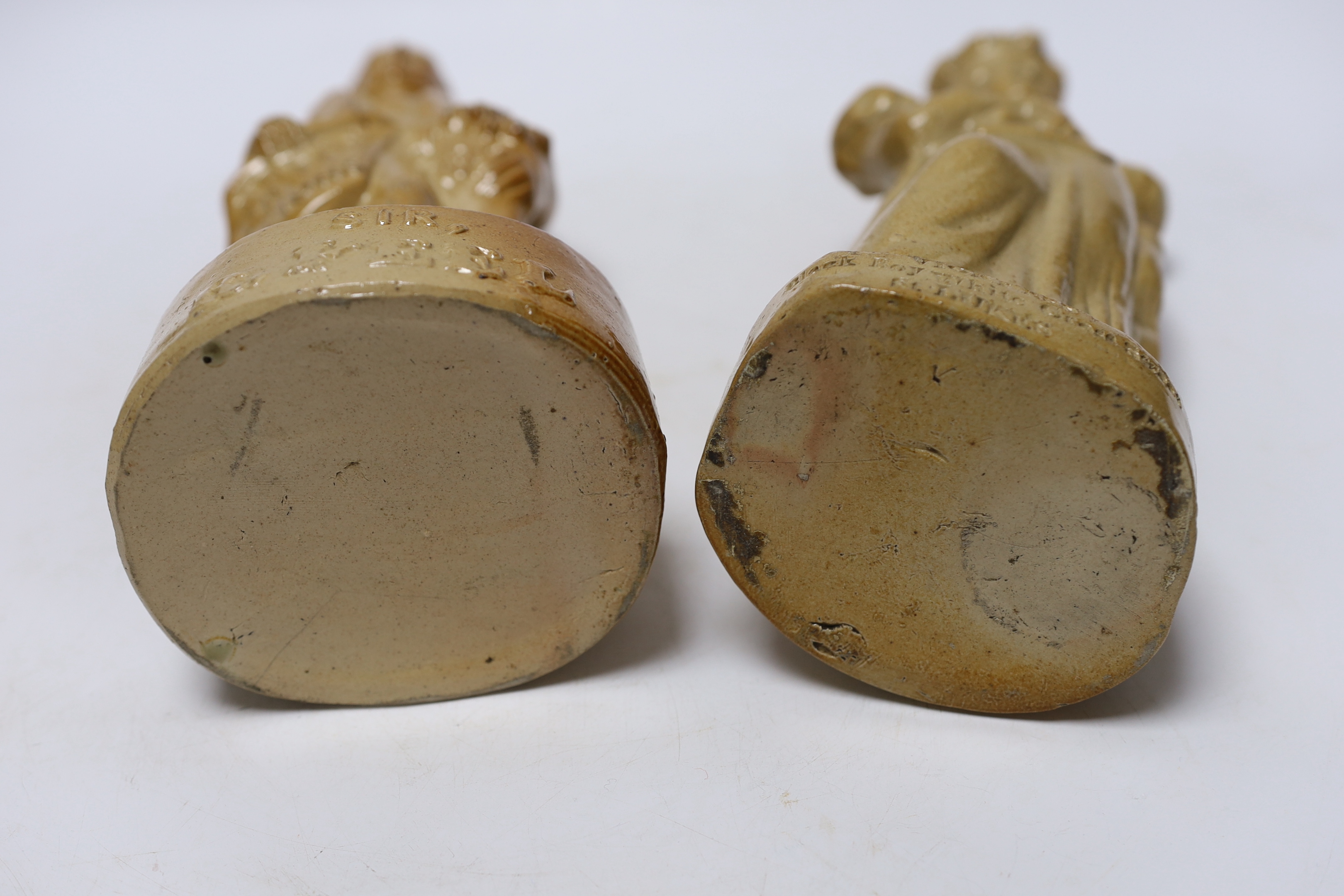 Two Victorian salt glaze spirit flasks, probably Lambeth, the first commemorating the repeal of the Corn Laws in 1846, modelled as Sir Robert Peel and the second modelled as Queen Victoria holding a scroll, impressed 